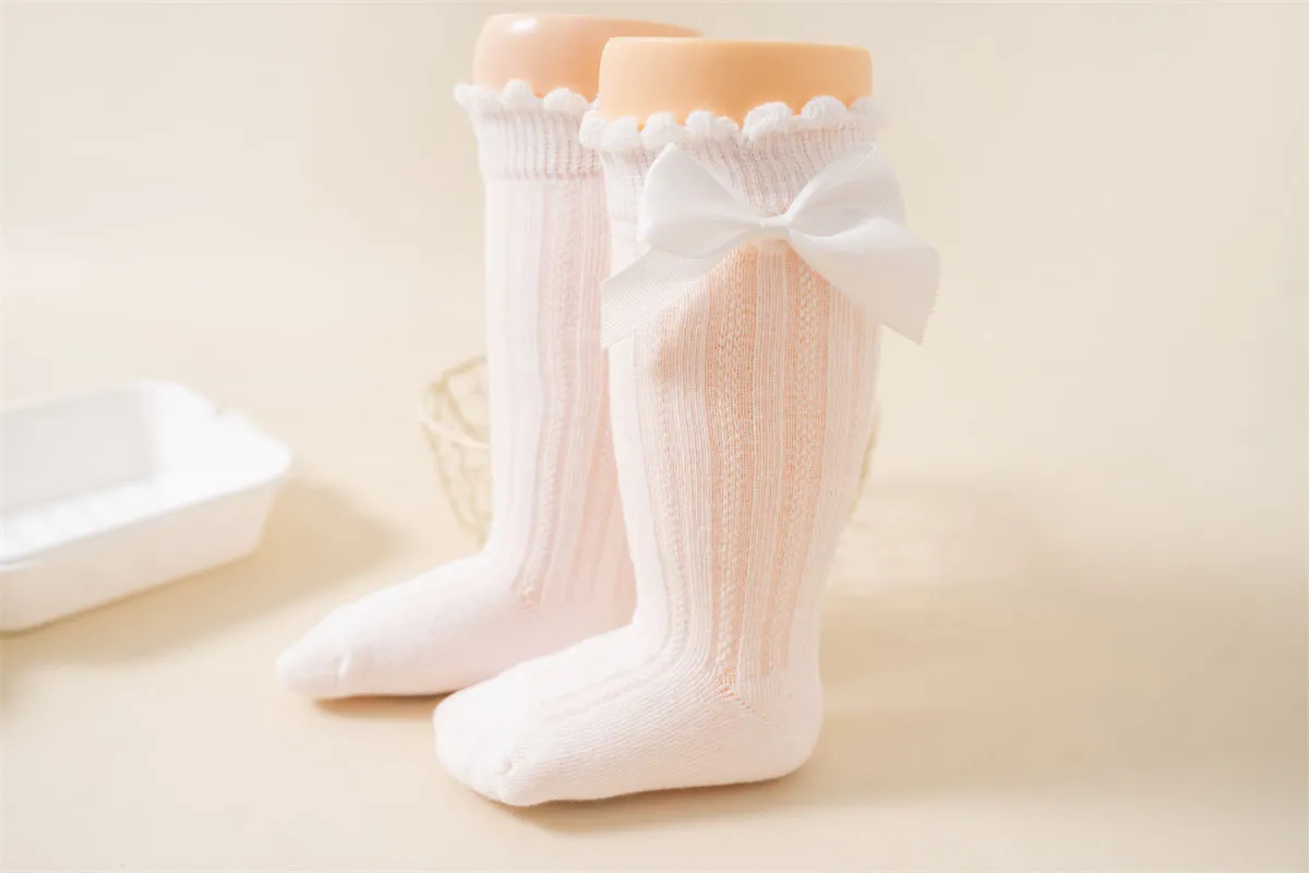 Baby girl wearing knee high bow socks