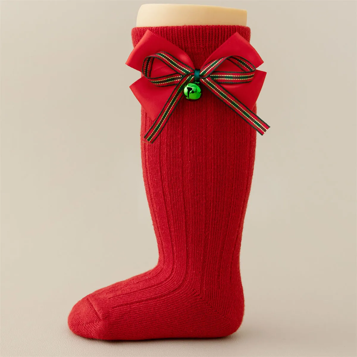 Baby girls knee high Christmas socks in red with a green jingle bell bow, wholesale supplier. Baby girls knee high Christmas socks in red with a green jingle bell bow, wholesale supplier.