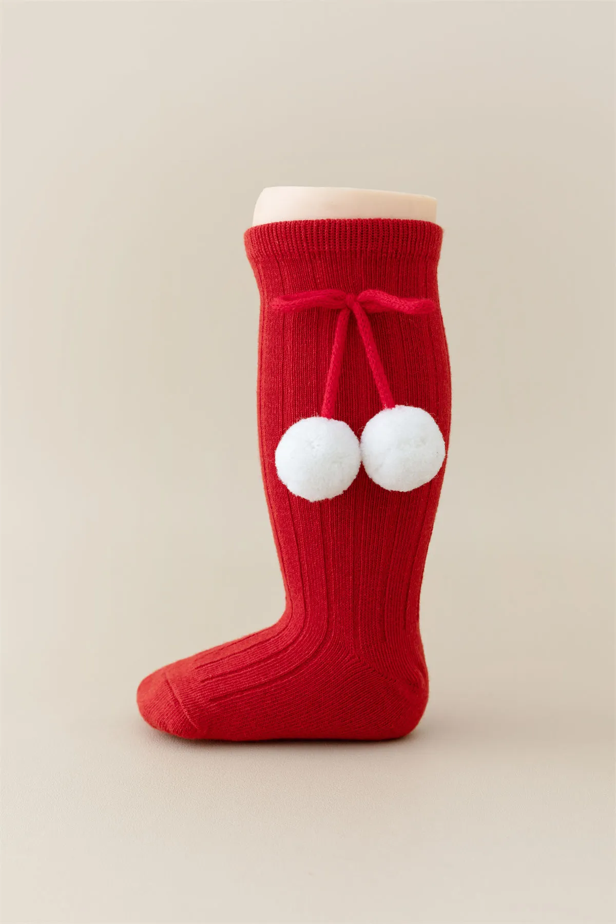 Baby girls knee high red socks with white pom pom bow tie, perfect for Christmas wholesale. Baby girls knee high red socks with white pom pom bow tie, perfect for Christmas wholesale.