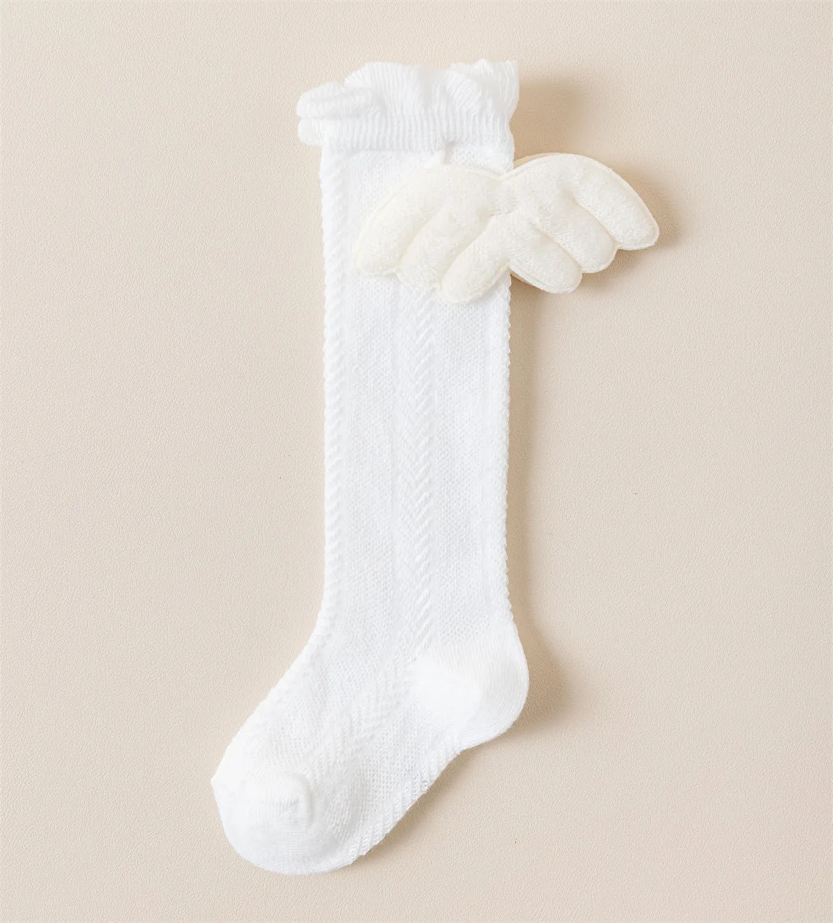White cotton baby socks with 3D angel wings design for infants. White cotton baby socks with 3D angel wings design for infants.