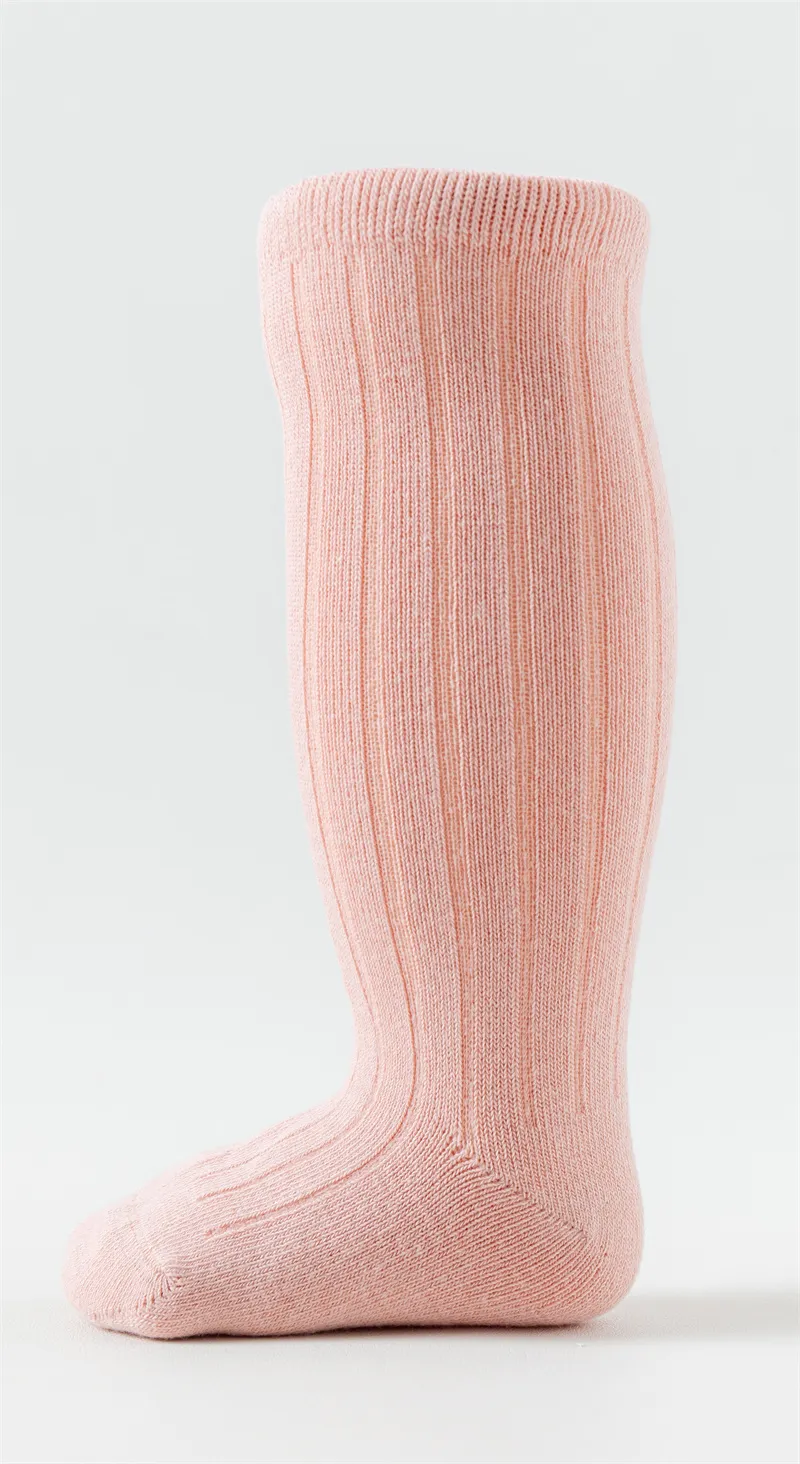 Baby girls knee high basic cotton socks in pink displayed on a foot model.