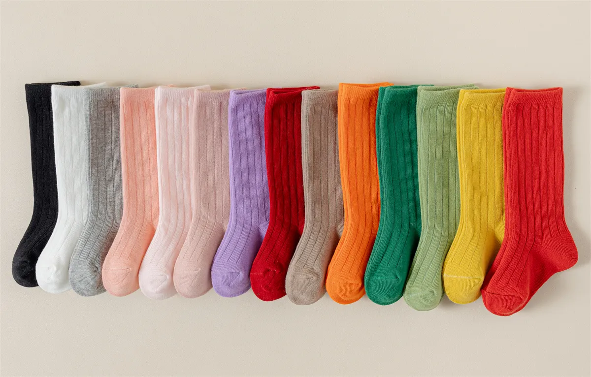 Wholesale solid color baby socks available in 16 vibrant colors for B2B buyers.